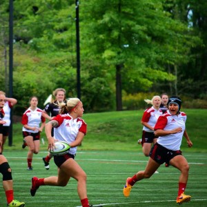 Byrge looks to make a pass off to her teammate. Photo Courtesy of Davenport University Rugby